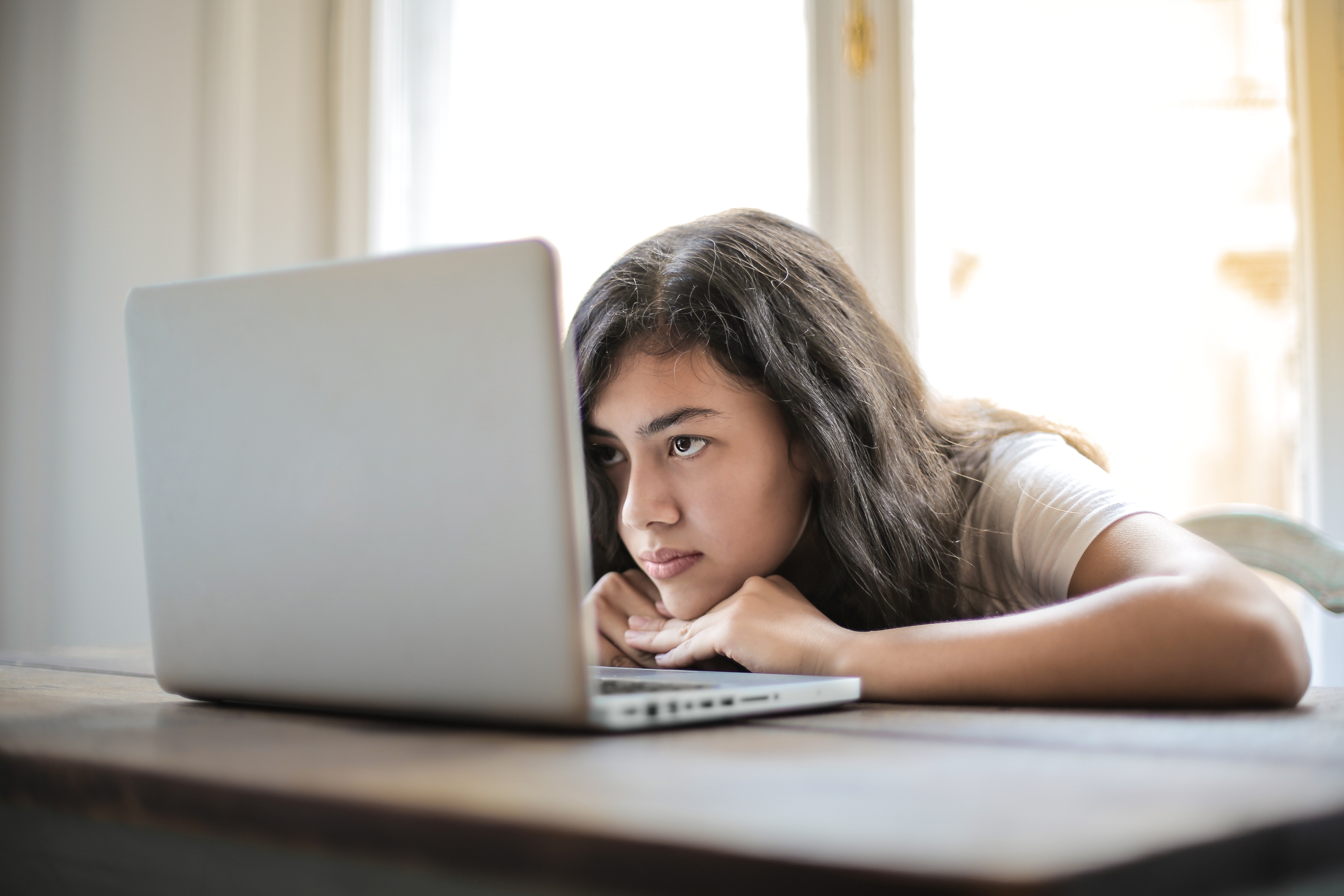 Jonge vrouw staart naar laptop 